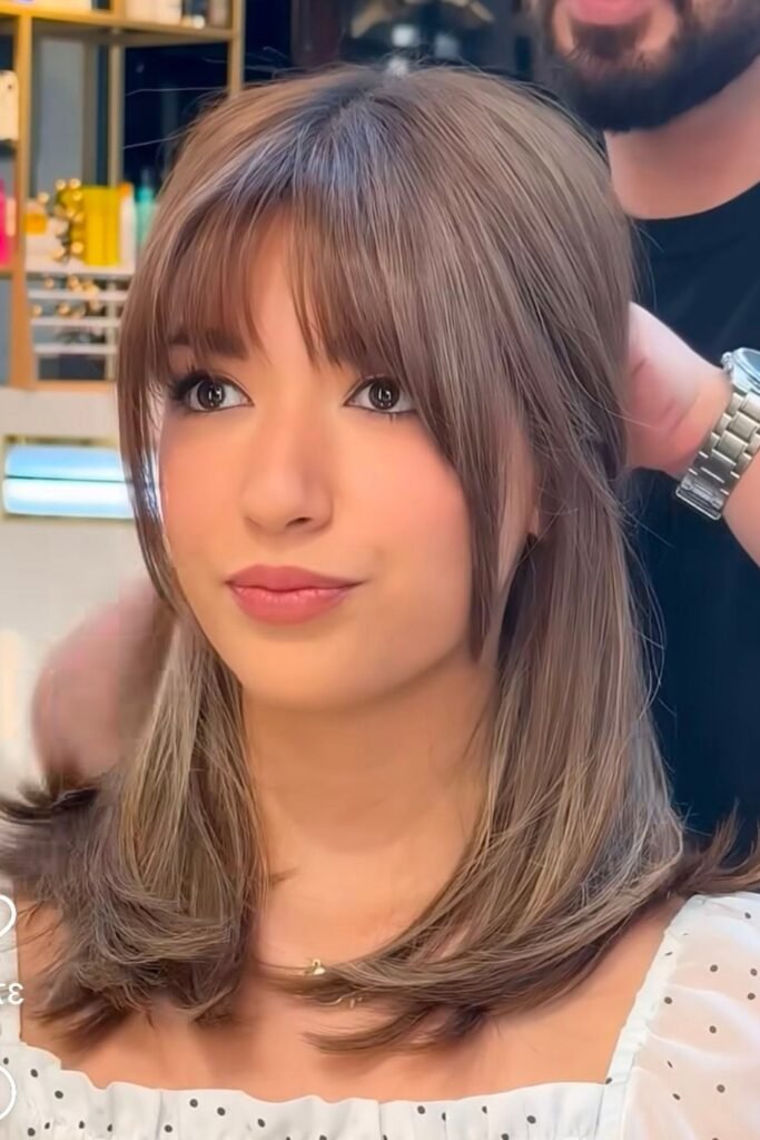 Mid-Length Layered Cut with Face-Framing Fringe