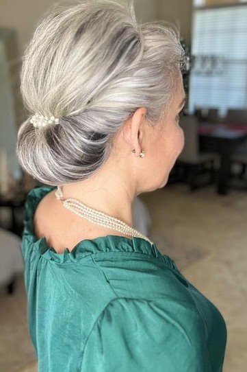 Sleek Low Chignon with Pearl Pin Accents