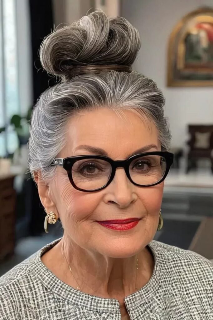 Structured High Bun with Side-Swept Bangs and Glasses