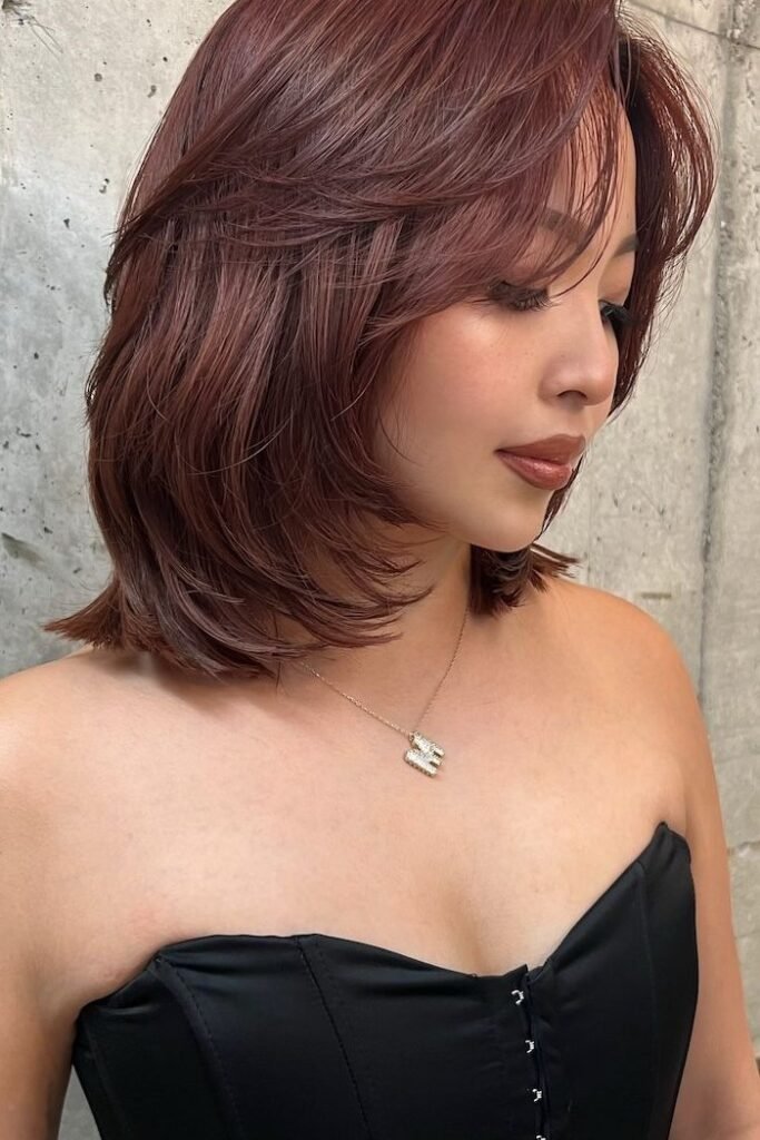 Deep Auburn Layered Shoulder-Length Hair with Curtain Bangs