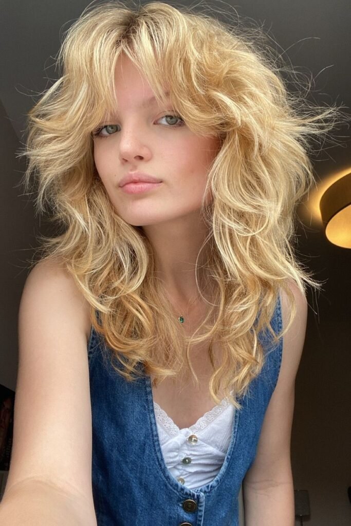 Golden Blonde Shaggy Cut with Face-Framing Waves