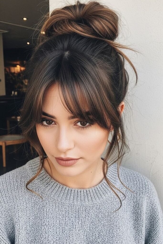 High Messy Bun with Face-Framing Pieces