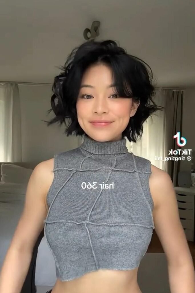 Jet Black Textured Bob with Soft Waves and Side-Swept Bangs