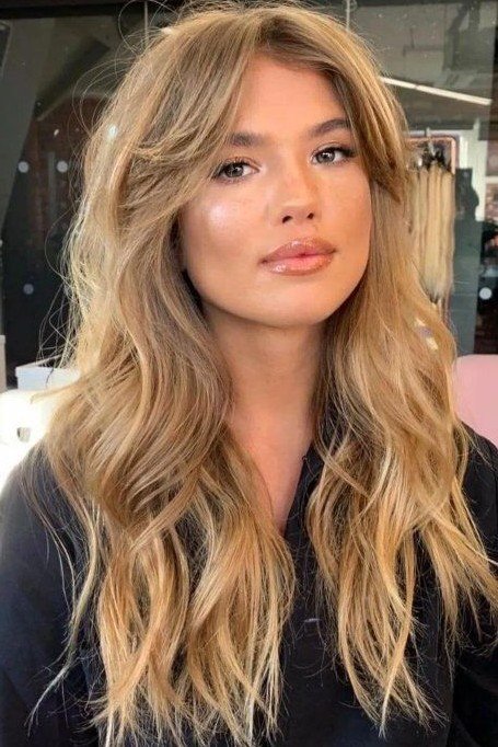 Long Layered Blonde Hair with Voluminous Curtain Bangs