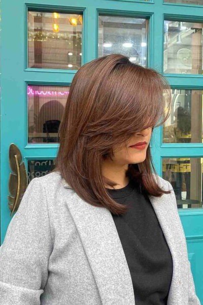 Medium Length Layered Cut with Deep Side-Swept Bangs