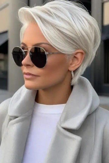 Platinum Blonde Pixie Cut with Voluminous Side Swept Bangs