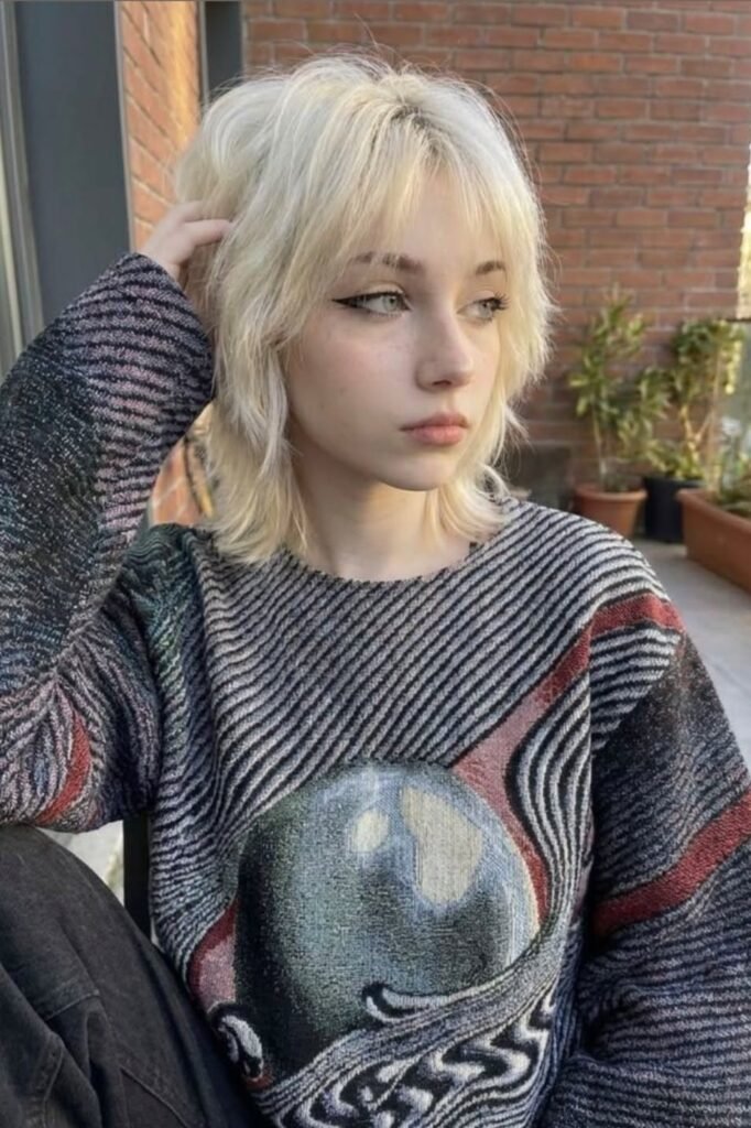 Platinum Blonde Shaggy Haircut with Wispy Bangs
