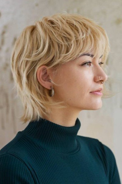 Short Blonde Layered Shag Haircut with Side-Swept Bangs