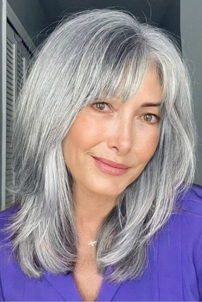 Shoulder-Length Layered Cut with Soft Face-Framing Bangs