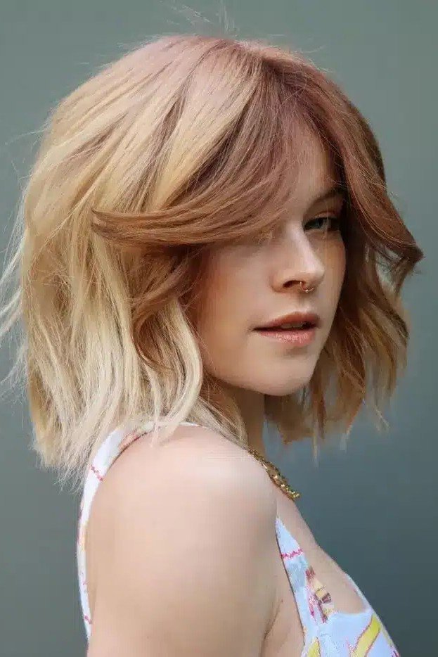 Textured Bob with Curtain Bangs and Blonde Highlights