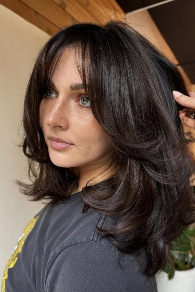 Voluminous Layered Cut with Face-Framing Bangs