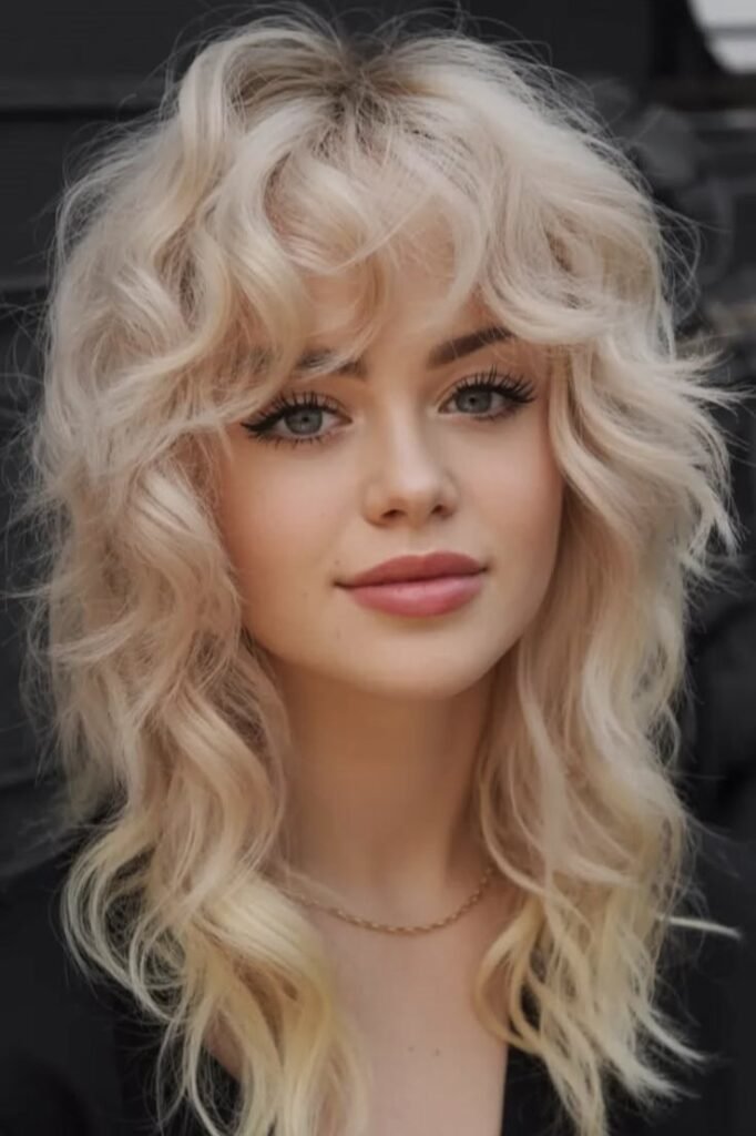 Bright Blonde Voluminous Curly Shag with Layered Fringe