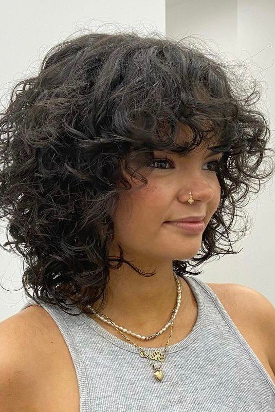 Layered Curly Cut with Soft Curls and Bangs