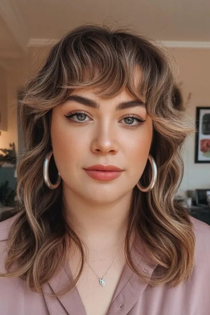 Light Brown Wavy Shag Haircut with Soft Face-Framing Bangs