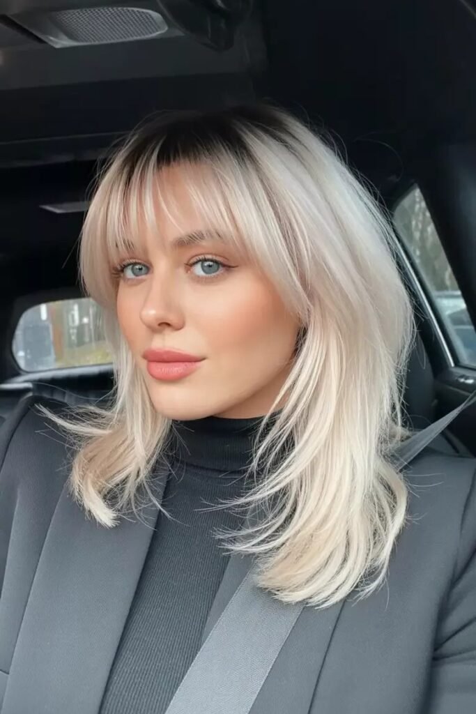 Long Layered Shag with Platinum Blonde Highlights and Bangs