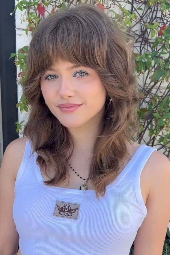 Medium Shaggy Layered Haircut with Full Bangs