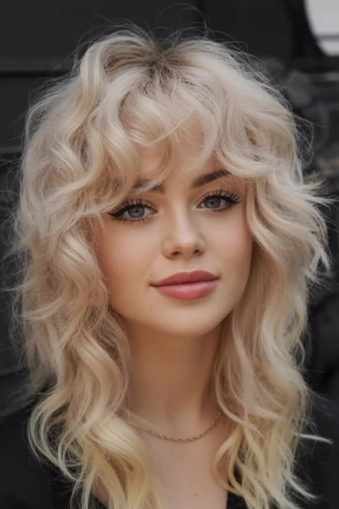 Platinum Blonde Curly Shag with Voluminous Texture and Soft Bangs