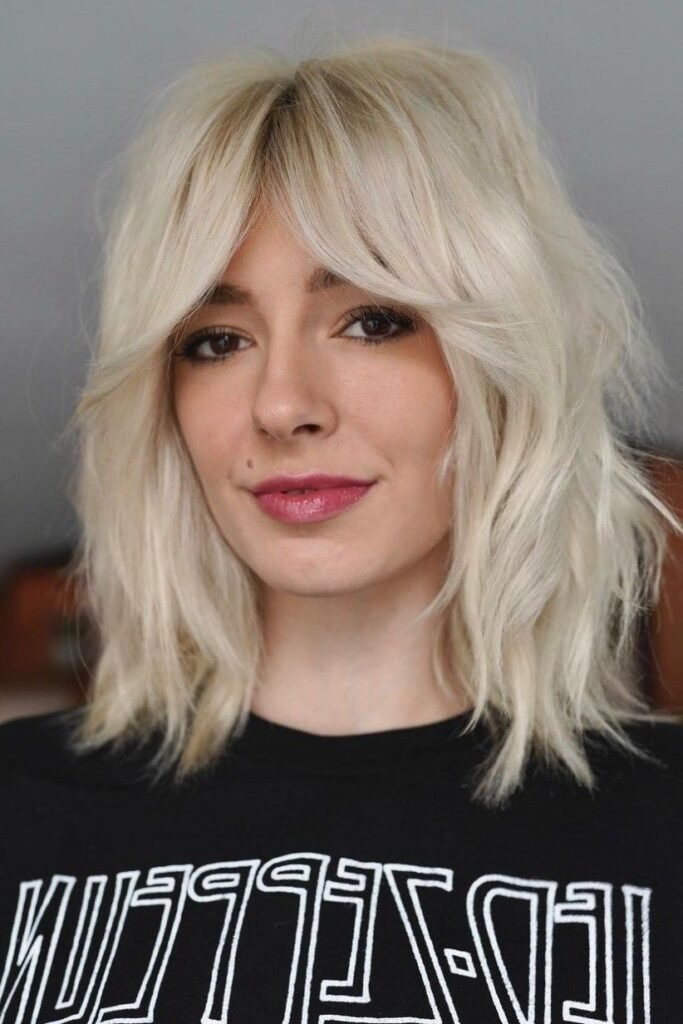 Platinum Blonde Medium Shag with Voluminous Curtain Bangs