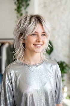 Platinum Blonde Shaggy Layers with Face-Framing Curtain Bangs