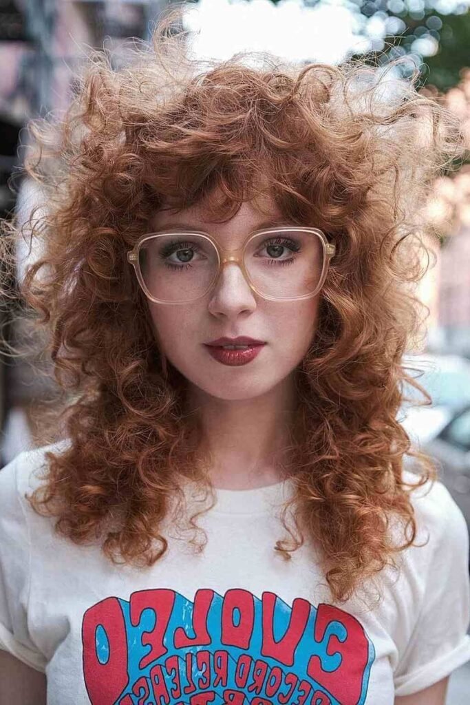 Reddish Curly Shag with Square Glasses and Bangs