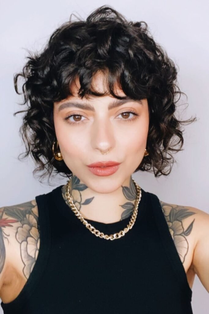 Short Curly Crop with Volume and Chunky Gold Chain Necklace