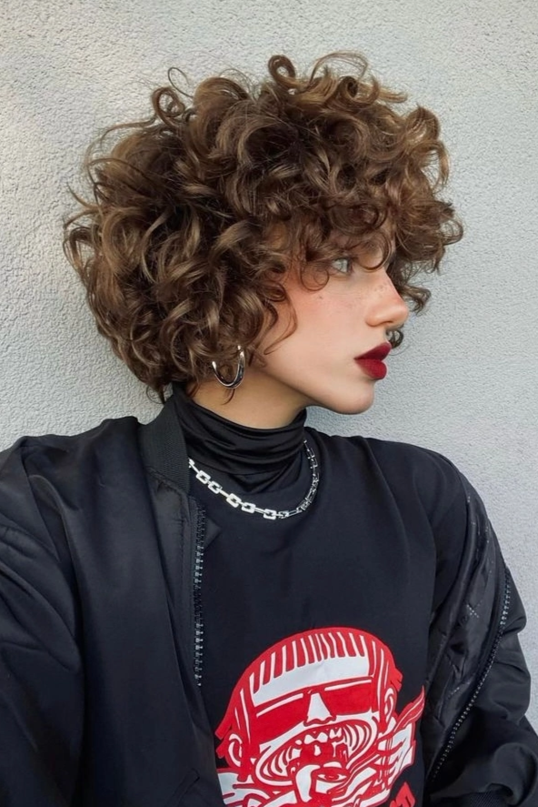 Voluminous Short Curly Bob with Side Profile and Hoop Earrings